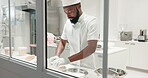 Man, chef and kneading dough on a restaurant kitchen counter for cooking job. Black person or professional baker working with food at work for pastry, pizza or baking recipe for a bakery or hotel