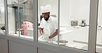 Chef, man and dough on a restaurant kitchen counter for cooking or catering job. Black person or professional baker working with food at work for pastry, pizza or baking recipe for a bakery or hotel