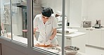 Kitchen, catering and a woman for baking as a job in a bakery or a hotel chef. Working, small business and a baker or hospitality employee rolling dough for food, pastry or cooking for a cafe
