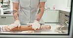 Hands, chef and roller with dough in restaurant or bakery kitchen table for cookies, cooking or pizza. Professional, person and rolling pin for pastry to bake cake, food or dessert in a diner