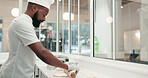 Chef, man and roller with dough in restaurant or bakery kitchen table for cookies, cooking or pizza. Professional, person and rolling pin for pastry to bake cake, food or dessert in a diner in Africa