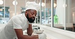 Tired, burnout and black man or chef at a bakery with anxiety from cooking, overtime or service. Sleeping, stress and an African baker or employee in hospitality industry with fatigue at a restaurant