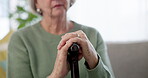 Hands, walking stick and elderly woman in home for support, healthcare and help in retirement. Closeup, lonely senior lady with disability and aid of parkinson, arthritis and rehabilitation of stroke