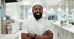 Face, chef and happy black man with arms crossed in kitchen at restaurant of hotel. Portrait, cooking and smile of confident worker, culinary expert and professional employee in Nigeria for catering