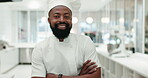 Face, chef and black man with arms crossed in kitchen at restaurant of hotel. Portrait, cooking and smile of confident worker, culinary expert and happy professional baker in Nigeria for catering