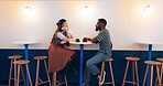 Couple, restaurant and date in night, coffee and happy for conversation, romance and listening with diversity. African man, woman and relax in cafe for tea, espresso and matcha in cafe, love and shop