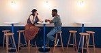 Couple, coffee shop and date in night, drink and happy for conversation, romance or listen with diversity. African man, woman and relax in cafe for tea, espresso or matcha in cafe, restaurant or shop