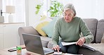Laptop, calculator and documents for finance with an old woman in the living room for retirement planning. Computer, writing and investment for pension with a senior adult on a sofa in her home