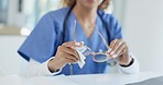 Nurse, woman and hands cleaning glasses with cloth, health and hygiene in hospital. Frame, lens and medical professional wipe with fabric for eye care, clear vision and remove dust on spectacles.