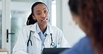 Hospital, consulting and doctor with patient for medical service, help and advice working on laptop. Healthcare, clinic and black woman with client in discussion for health exam, diagnosis or results