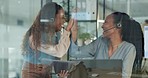 Teamwork, call center and women high five on tablet for help, customer support and achievement. Collaboration, communication and excited workers celebrate for sale, contact business and CRM service
