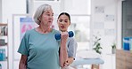 Physiotherapist, office and old woman with dumbbells, support and healthcare rehabilitation with consultation. Senior person, physical therapy and elderly lady with wellness, healing and recovery