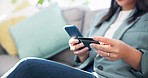 Closeup, home and woman with a smartphone, credit card and ecommerce with payment, financial transaction and investment. Person on a sofa, password or girl with a cellphone online shopping or banking