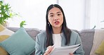 Wave, video call and Asian woman on sofa for job interview, virtual conference or networking for remote work. Hello, hr paperwork or online meeting with girl in home office for webinar consultation.