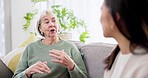 Senior woman, talking and couch with daughter, bonding and mother together with love and mom. Home, conversation and retirement on a sofa with story, lounge and communication with elderly person