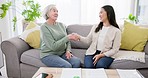 Financial advisor, senior woman and handshake for asset management, agreement and signature or contract documents. Broker or notary shaking hands with elderly client on home sofa for pension success