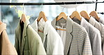 Fashion, rack and clothing line of empty boutique store for retail shopping, accessory or outfit choice. Room, shop or clothes and suits or fashionable attire for purchase, buying or discount sale