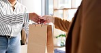 Woman, fashion designer and paper bag to customer in small business, purchase or buying at boutique store. Closeup of female person, hands and client buying clothing or shoes at retail shop or mall