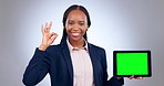 Happy black woman, tablet and green screen mockup with okay sign against a grey studio background. African female person and technology display or tracking markers in business advertising or approval