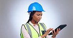 Woman, construction and engineering with tablet in studio of project management, industrial development or technician planning on grey background. African architect, contractor and digital technology