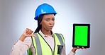 Black woman, architect and tablet mockup with thumbs down on green screen against a studio background. Portrait of African female person, engineer or contractor with technology display in bad review