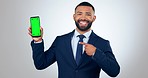 Business man, phone and green screen, presentation or advertising space for social media or online information. Face of corporate person on mobile app, tracking markers and studio or white background