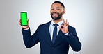 Professional man, phone and green screen presentation or trading mockup in OK, yes or agreement emoji. Face of business person or trader on mobile app, tracking markers and studio or white background