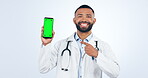 Doctor, phone and green screen presentation of healthcare info, FAQ and communication in studio. Face of medical man with mobile mockup, telehealth and contact, tracking markers and white background
