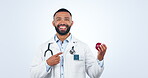 Doctor, portrait and smile in studio for nutrition, healthy diet and medical wellness on white background. Nutritionist, professional man and happiness with fruit in hand for vegan lifestyle