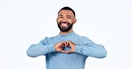 Happy, face and man with heart hands in studio for thank you, voice or kindness, hope or care on white background. Smile, portrait and male model with hand emoji for support, vote or love promo