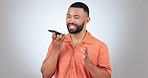 Speaker, phone call and happy man win studio with conversation, laugh or speech to text on grey background. Smartphone, app and male model with talking, recording or online, chat and communication