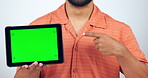 Man, tablet and hand pointing to green screen in studio for marketing or advertising tracking markers on white background. Body, person and smartphone with product placement for social media website