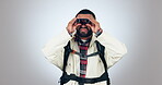 Binocular, trekking and man with backpack for travel, adventure and explore on white background. Person hiking, lens vision and sightseeing or birdwatching gear for safari holiday on a studio mockup