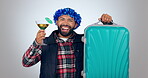 Man, dance with cocktail and suitcase for travel opportunity, vacation or excited for holiday in studio. Face of happy person with tropical drink, luggage and journey celebration on white background