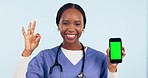 Doctor, phone green screen and OK or yes hands for healthcare presentation, medical app and emoji in studio. Face of african woman or nurse on mobile telehealth, tracking markers and blue background