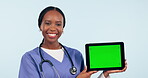 Doctor, woman and tablet green screen for healthcare presentation, online services or advertising in studio. Face of medical nurse, digital mockup or telehealth, tracking markers and blue background