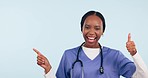 Happy black woman, doctor and pointing with thumbs up in success against a studio background. Portrait of African female person, medical or healthcare nurse show list with like emoji or yes in mockup