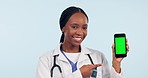 Black woman, doctor and phone with green screen mockup for advertising against a studio background. Portrait of African female person, medical or healthcare professional smile with smartphone display