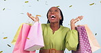 Woman, winner confetti and shopping bag for discount, sale and retail giveaway or e commerce competition in studio. Wow, surprise and excited, african customer dance with prize on a white background