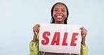 Happy black woman, poster and sale for discount, shopping or commercial against a studio background. Portrait of excited African female person with billboard for advertising, branding or marketing