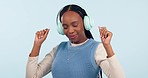 Woman, dance and music headphones in studio to celebrate freedom, party and hearing audio song on white background. Happy african model listening to multimedia podcast, sound and radio subscription