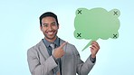 Business man, speech bubble and point in studio, happy and excited face with mockup space by blue background. Entrepreneur, paper poster and billboard in portrait, quote and announcement with review