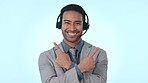 Call center man, face and point in studio with choice, opinion and happy for review by blue background. Telemarketing consultant, agent and smile in portrait for vote, voice or feedback with decision