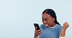 Happy black woman, phone and fist pump in celebration, good news or promotion against a studio background. Excited African female person in happiness with mobile smartphone app for winning on mockup