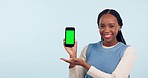 Happy black woman, phone and green screen in advertising or marketing against a studio background. Portrait of African female person with mobile smartphone app, display or tracking markers on mockup