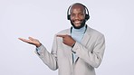 Happy black man, call center and pointing to palm in advertising or list against a studio background. African male person or consultant showing sale or discount in customer service on mockup space