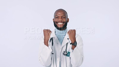 Hands, celebration and face of man doctor in studio with winning, fist