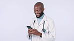 Phone, smile and doctor typing in studio for online message consultation with mockup. Technology, telehealth and black man healthcare worker doing medical research on cellphone by white background.