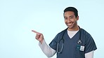 Happy asian man, doctor and pointing to steps in choice, decision or option against a studio background. Portrait of male person, medical or healthcare nurse showing list, select or process on mockup