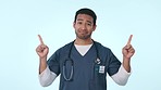Face, man and doctor pointing, smile and decision with options on a blue studio background. Portrait, Japanese person or medical professional with a choice, healthcare or model with a shrug or review